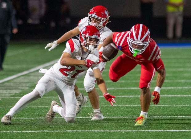 Mater Dei's Justin Lewis (33) escapes two Kahuku defenders during a non-league football game between Kahuku of Hawaii and Mater Dei at Santa Ana Stadium Friday Sept. 5, 2025. (Photo by Michael Goulding, Contributing Photographer)