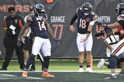 Aug 17, 2025; Chicago, Illinois, USA;  Chicago Bears wide receiver Olamide Zaccheaus (14) celebrates with Chicago Bears quarterback Caleb Williams (18) after scoring a touchdown against the Buffalo Bills during the first half at Soldier Field. 