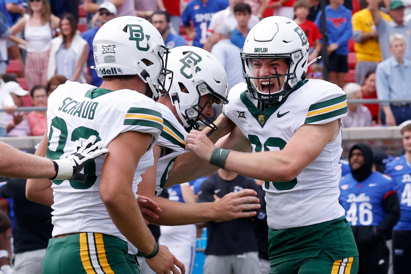 Baylor place kicker Connor Hawkins (96), right, celebrates with his teammates after he...