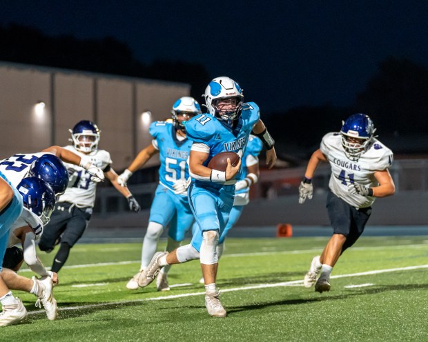 Pleasant Valley High quarterback Brayden Wynkoop (11) runs up the...