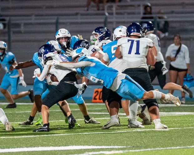 Pleasant Valley High’s James Stapp (19) dives to bring down...