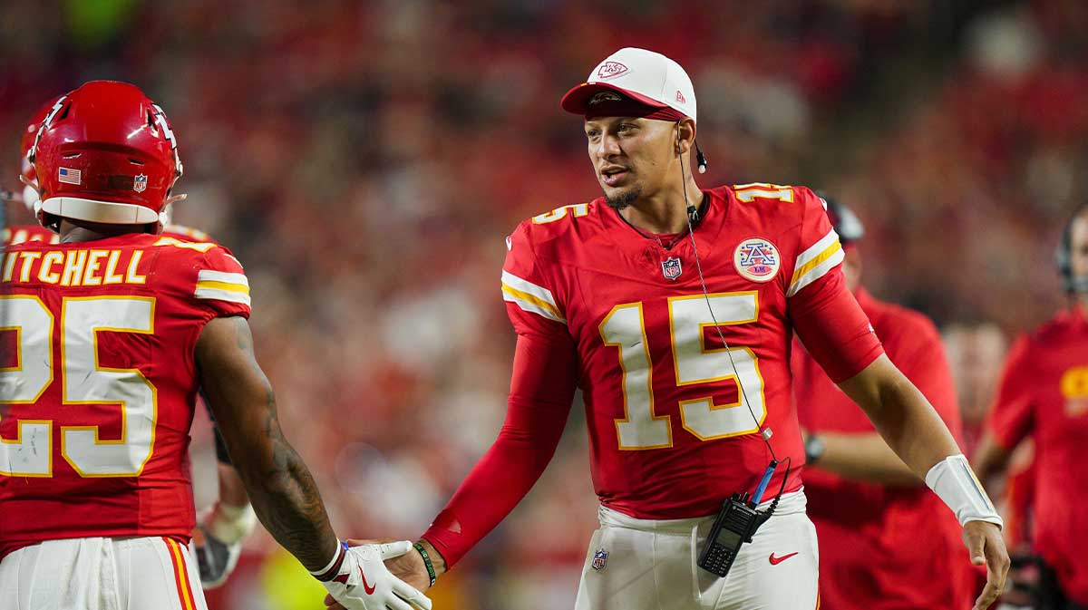 Kansas City Chiefs quarterback Patrick Mahomes (15) congratulates Kansas City Chiefs running back Elijah Mitchell (25) after scoring a touchdown against the Chicago Bears at GEHA Field at Arrowhead Stadium. 