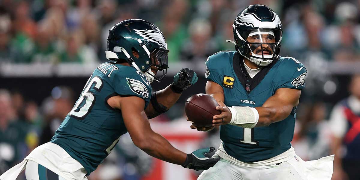 Philadelphia Eagles quarterback Jalen Hurts (1) hands off the ball to running back Saquon Barkley (26) during the third quarter of the game against the Dallas Cowboys at Lincoln Financial Field.