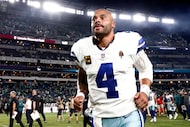 Dallas Cowboys quarterback Dak Prescott (4) jogs off the field after losing an NFL game to...