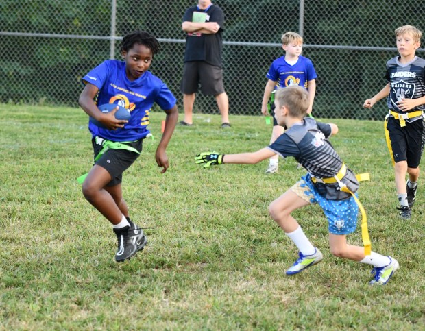Rams Sam Boateng tries to elude the Raiders Cade Junkin. (Photo by Rick Cawley)