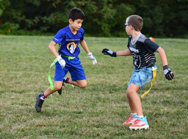 Rams Jackson Brogan tries to get free from Raiders defender...