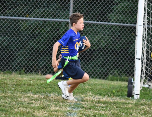 Rams Patrick Ward races up the left sideline on his...