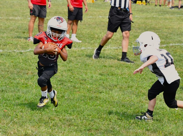 Eagles Mitchell Long closes in on Shane Davis. (Photo by...