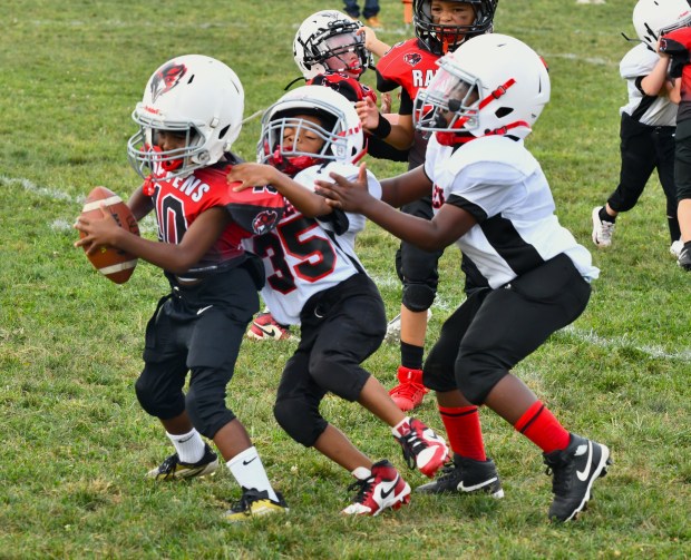 Eagles Ayden Gooding, left, and Austin Clark tackle Shane Davis...