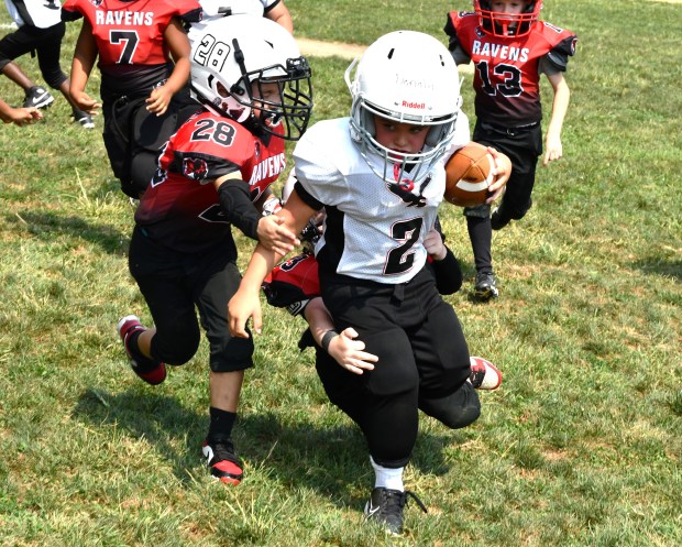 Donald Falso tries to elude the tackle by Bentley Windle...