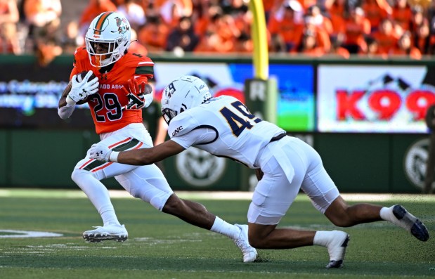 Colorado State running back Justin Marshall (29) fends off Northern Colorado defensive back Cam Chapa (49) during the Colorado State Rams football game against the Northern Colorado Bears at Canvas Stadium at Colorado State University in Fort Collins Saturday, Sept. 7, 2024. (Photo by Alex McIntyre/Special to The Denver Post)