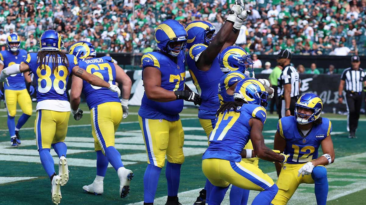 Los Angeles Rams running back Kyren Williams (23) reacts with wide receiver Davante Adams (17) and wide receiver Puka Nacua (12) after a touchdown during the second half at Lincoln Financial Field.