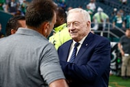 Dallas Cowboys owner and general manager Jerry Jones talks on the field before an NFL game,...