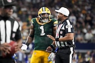 Green Bay Packers linebacker Micah Parsons (1) looks for a call from referee Ronald Torbert...
