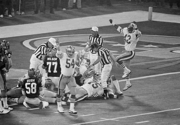San Francisco 49ers players Craig Puki (54) and Ronnie Lott (42) react after the 49ers stopped a Cincinnati Bengals drive on Jan. 24, 1982, in Pontiac, Mich., within the one-yard-line on a fourth down in the third quarter of Super Bowl XVI. Bengals players visible are center Blair Bush (58) and tackle Mike Wilson (77). (AP Photo)