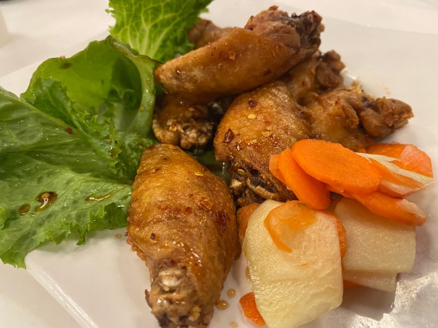 The Vietnamese wings at Pho Ha Noi restaurants in Cupertino and San Jose are coated in a sauce of savory nuoc cham and garic. (Linda Zavoral/Bay Area News Group)