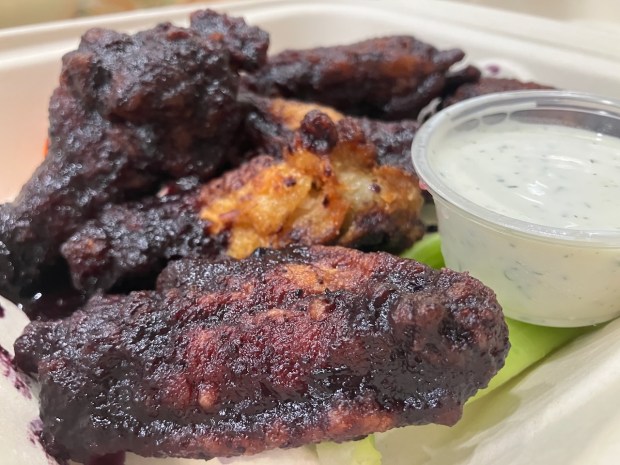 The blueberry barbecue wings from Ghostwood Kitchen in Redwood City added a seasonal sweetness with berry notes to this football season snacking favorite. (Kate Bradshaw/Bay Area News Group)