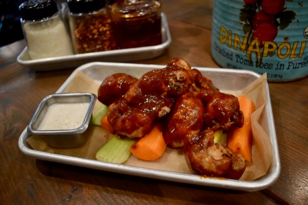 For those looking for a gluten-free or vegetarian alternative to chicken wings this upcoming football season, State of Mind Pizza House serves cauliflower "wings," coated in buttermilk, breaded in gluten-free flour and fried, then topped with sauce. In this case, it's the chipotle cola barbecue sauce. (Kate Bradshaw/Bay Area News Group)