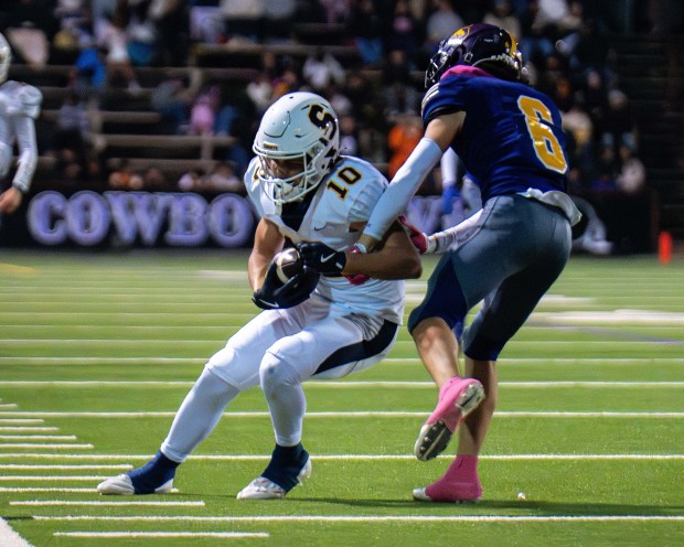 Soquel High receiver Hudson Summerrill makes a catch along the sidelines while defended by Salinas' Wyatt Maravilla during the teams' PCAL Gabilan Division football game in Salinas on Friday. (Raul Ebio - Santa Cruz Sentinel)