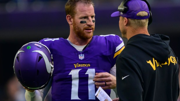 Minnesota Vikings quarterback Carson Wentz (11) talks with quarterback coach Josh McCown during a timeout against the Cincinnati Bengals in the third quarter of a NFL game at U.S. Bank Stadium in Minneapolis on Sunday, Sept. 21, 2025. (John Autey / Pioneer Press)