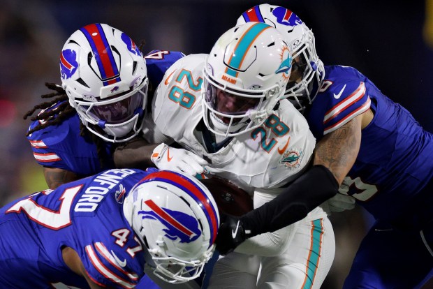 de'von Achane #28 of the Miami Dolphins is tackled by the Buffalo Bills in the first half of the game at Highmark Stadium on Sept. 18, 2025 in Orchard Park, New York. (Photo by Bryan M. Bennett/Getty Images)