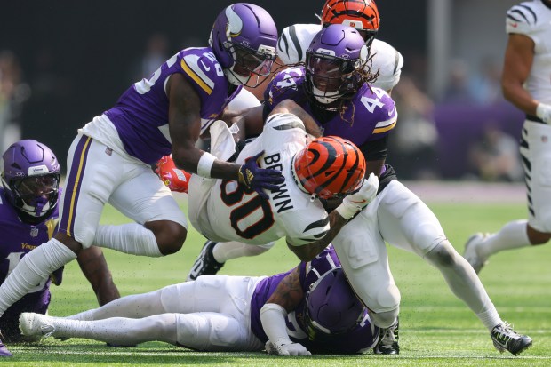 Chase Brown #30 of the Cincinnati Bengals is tackled by Josh Metellus #44 of the Minnesota Vikings during the second quarter at U.S. Bank Stadium on Sept. 21, 2025 in Minneapolis, Minnesota. (Photo by Adam Bettcher/Getty Images)
