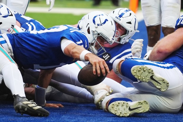 Indianapolis Colts quarterback Daniel Jones (17) scores a touchdown during the second half of an NFL football game against the Miami Dolphins on Sunday, Sept. 7, 2025, in Indianapolis. (AP Photo/Darron Cummings)