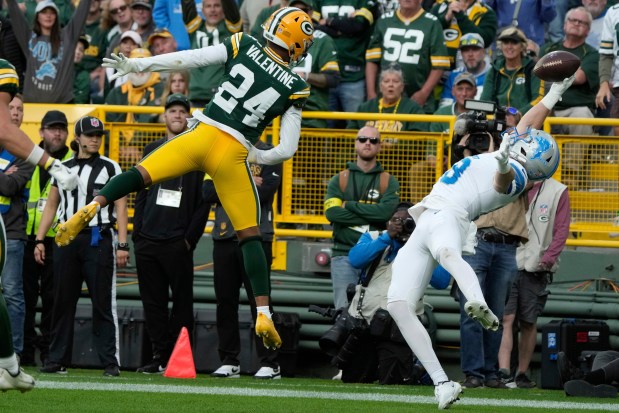 Detroit Lions' Isaac TeSlaa catches a touchdpown pass in front of Green Bay Packers' Carrington Valentine during the second half of an NFL football game Sunday, Sept. 7, 2025, in Green Bay, Wis. (AP Photo/Morry Gash)