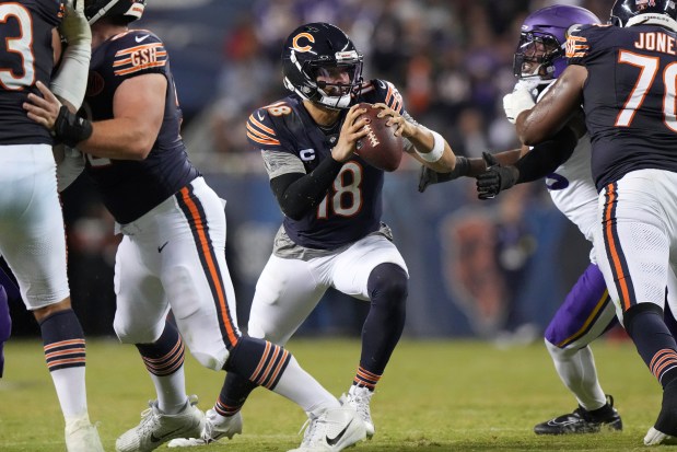 Chicago Bears quarterback Caleb Williams (18) runs with a ball during the second half of an NFL football game against the Minnesota Vikings in Chicago, Monday, Sept. 8, 2025. (AP Photo/Nam Y. Huh)