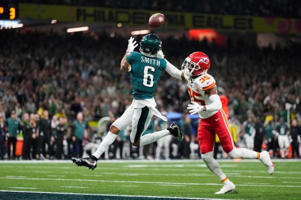 Philadelphia Eagles wide receiver DeVonta Smith (6) makes a touchdown catch past Kansas City Chiefs cornerback Jaylen Watson (35) during the second half of Super Bowl LIX Sunday, Feb. 9, 2025, in New Orleans. (AP Photo/Abbie Parr)