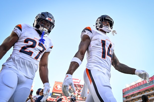 Courtland Sutton (14) and J.K. Dobbins (27) of the Denver Broncos walk off the field before the first quarter against the San Francisco 49ers at Levi's Stadium in Santa Clara, California on Saturday, Aug. 9, 2025. (Photo by AAron Ontiveroz/The Denver Post)