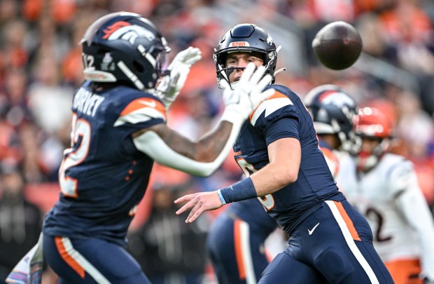 Bo Nix (10) of the Denver Broncos pitches to RJ Harvey (12) during the first quarter against the Cincinnati Bengals at Empower Field at Mile High on Monday, Sept. 29, 2025. (Photo by AAron Ontiveroz/The Denver Post)