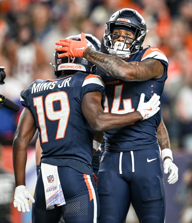 Courtland Sutton (14) of the Denver Broncos celebrates catching a receiving touchdown with teammate Marvin Mims Jr. (19) during the second quarter against the Cincinnati Bengals at Empower Field at Mile High on Monday, Sept. 29, 2025. (Photo by AAron Ontiveroz/The Denver Post)