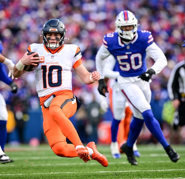 Bo Nix (10) of the Denver Broncos rushes for a gain against the Buffalo Bills during the fourth quarter of the Bills' 31-7 AFC divisional playoff win at Highmark Stadium in Orchard Park, New York on Sunday, Jan. 12, 2025. (Photo by AAron Ontiveroz/The Denver Post)