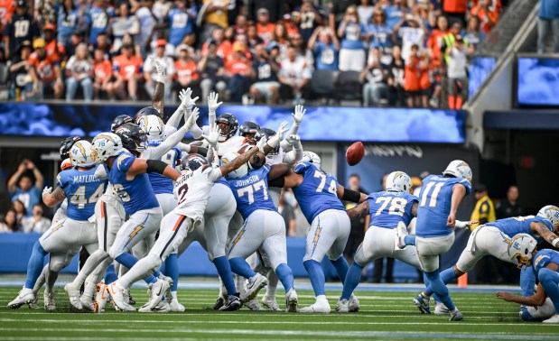 Cameron Dicker (11) of the Los Angeles Chargers makes a game-winning field goal as the Denver Broncos defense attempts to block the ball mid flight during the fourth quarter of the Chargers' 23-20 win at SoFi Stadium in Inglewood, California on Sunday, Sept. 21, 2025. (Photo by AAron Ontiveroz/The Denver Post)