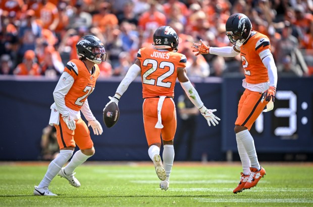 Brandon Jones (22) of the Denver Broncos celebrates recovering a fumble by Tony Pollard (20) of the Tennessee Titans alongside teammates Riley Moss (21) and Pat Surtain II (2) during the second quarter at Empower Field at Mile High on Sunday, Sept. 7, 2025. (Photo by AAron Ontiveroz/The Denver Post)