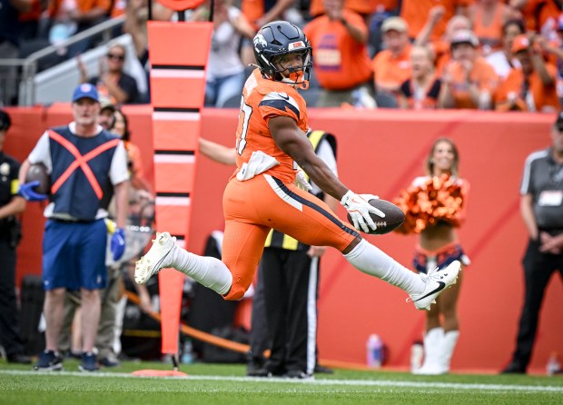 J.K. Dobbins (27) of the Denver Broncos rushes for a...