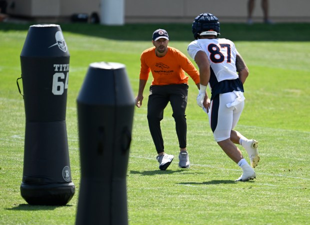 Tight Ends Coach Declan Doyle works a drill with Denver Broncos tight end Tommy Hudson (87) during the Denver Broncos training camp at Centura Health Training Center on Aug. 8, 2023 in Centennial. (Photo by RJ Sangosti/The Denver Post)