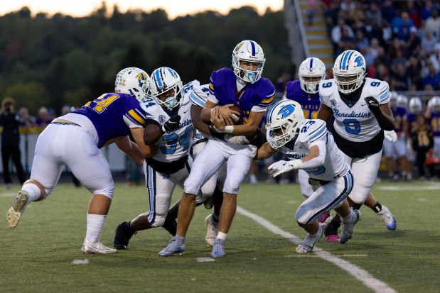 Benedictine defenders converge for a tackle Sept. 12 at NDCL. (Brian Fisher - for The News-Herald)