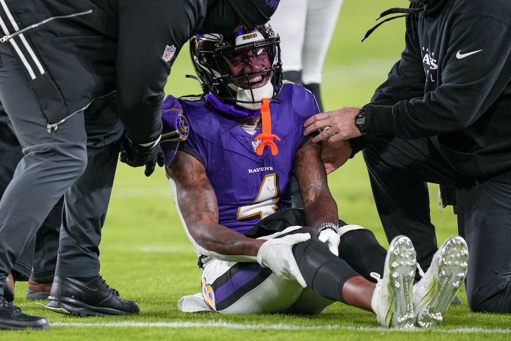 Baltimore Ravens wide receiver Zay Flowers (4) clutches his knee on the ground after making a completion during a game against the Cleveland Browns at M&T Bank Stadium in Baltimore, Md. on Saturday, January 4, 2025.