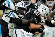 Las Vegas Raiders quarterback Aidan O'Connell is sacked by Carolina Panthers linebacker...