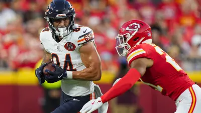 Aug 22, 2025; Kansas City, Missouri, USA; Chicago Bears tight end Colston Loveland (84) runs with the ball against Kansas City Chiefs safety Jaden Hicks (21) during the first half at GEHA Field at Arrowhead Stadium.