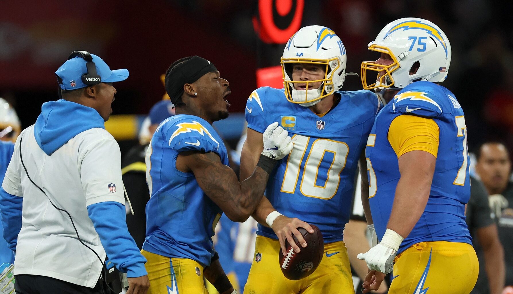 Chargers quarterback Justin Herbert celebrates a win over the Chiefs with his teammates in the 2025 season.