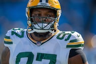 FILE - Green Bay Packers defensive tackle Kenny Clark (97) warms up before an NFL football...