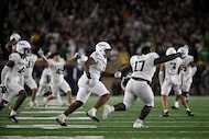 Texas A&M players run onto the field after defeating Notre Dame 41-40 in an NCAA football...