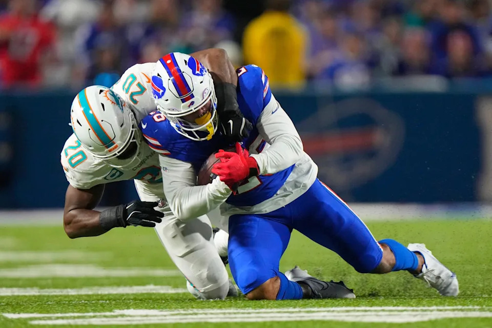 Sep 18, 2025; Orchard Park, New York, USA; Miami Dolphins linebacker Jordyn Brooks (20) tackles Buffalo Bills running back Ty Johnson (26) in the second half at Highmark Stadium. Mandatory Credit: Gregory Fisher-Imagn Images