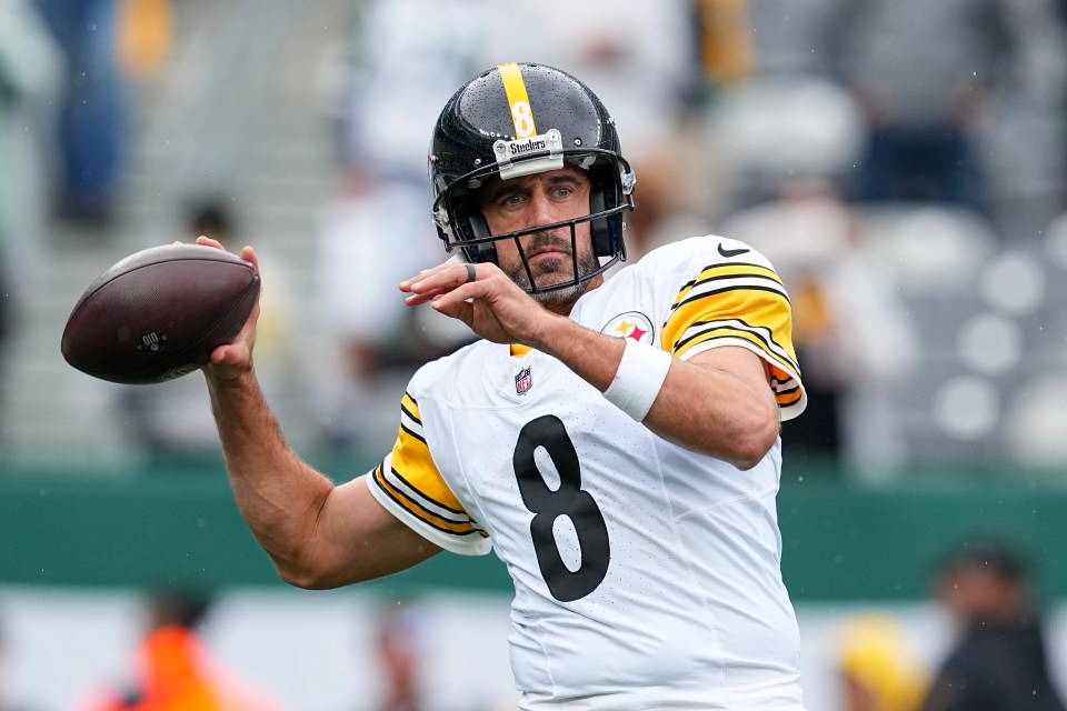 Aaron Rodgers, #8, warming up before a football game.