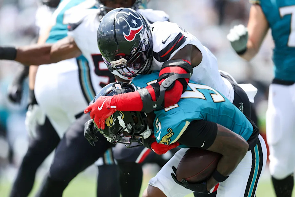 Sep 21, 2025; Jacksonville, Florida, USA; Houston Texans linebacker Azeez Al-Shaair (0) tackles Jacksonville Jaguars wide receiver Dyami Brown (5) during the second quarter at EverBank Stadium. Mandatory Credit: Morgan Tencza-Imagn Images