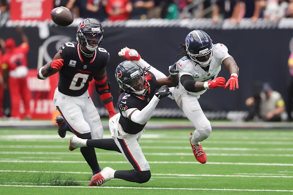 Sep 28, 2025; Houston, Texas, USA; Tennessee Titans wide receiver Calvin Ridley (0) is unable to catch a pass as Houston Texans safety Calen Bullock (2) defends during the fourth quarter at NRG Stadium. Mandatory Credit: Troy Taormina-Imagn Images
