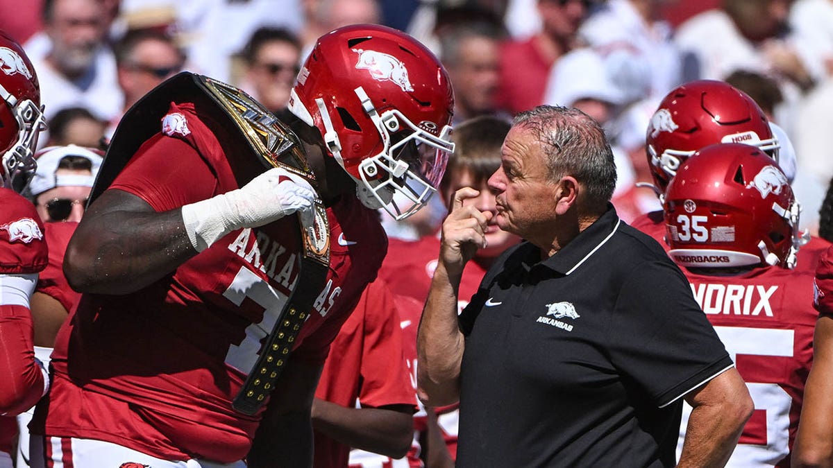 Sam Pittman talks to a player